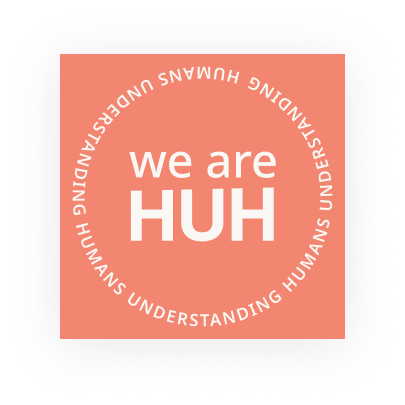 the weareHUH logo, an orange square with the text we are HUH stacked in the middle with the words humans understanding humans repeating in a circle around the outside.
